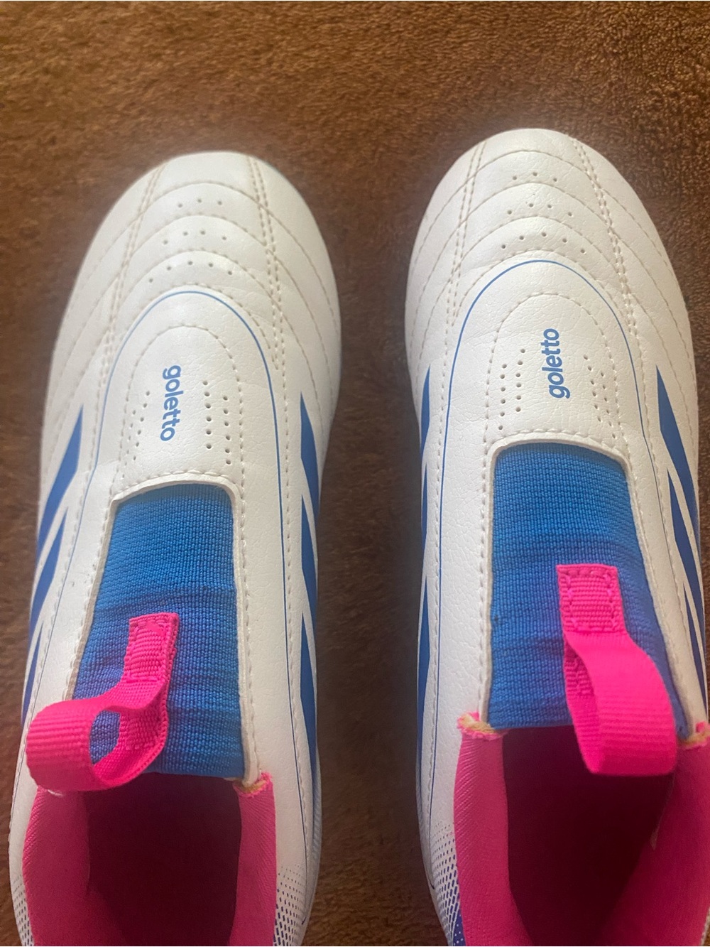 Goletto Kids cleats White and Blue Slip-On Athletic Shoes with Pink Accents.